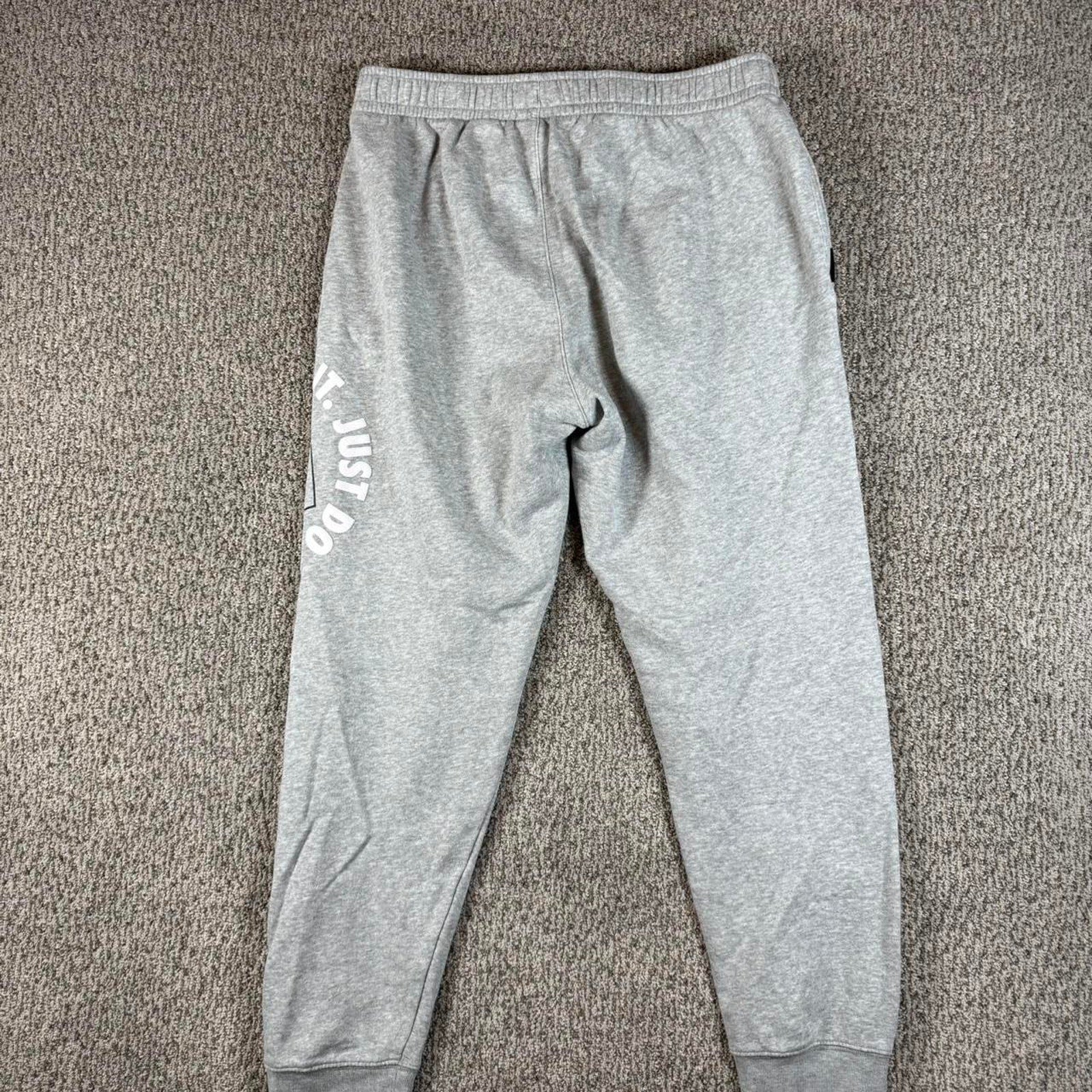Grey nike joggers with white