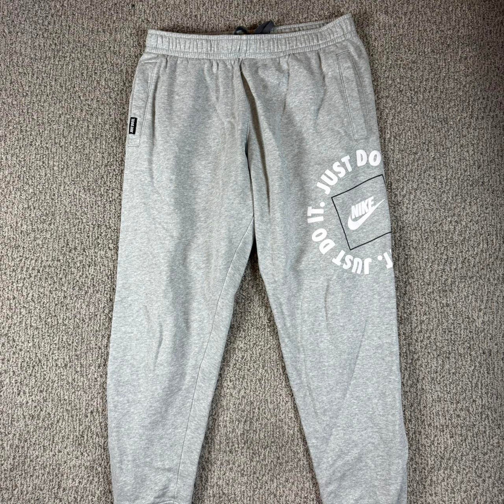 Grey nike joggers with white