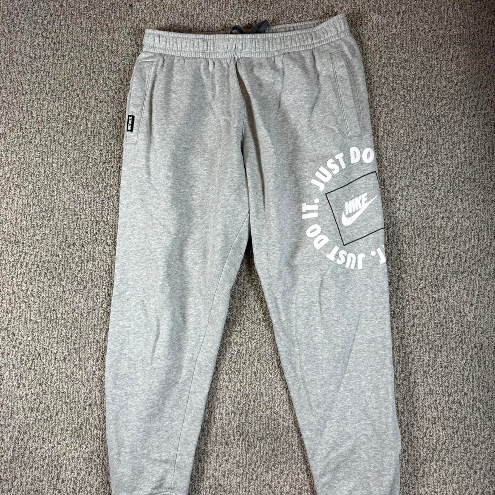 Grey nike joggers with white